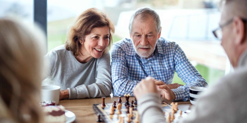 Elderly people playing board game
